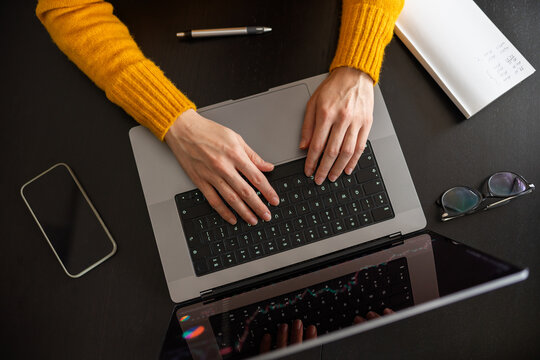 View from above of anonymous person using computer