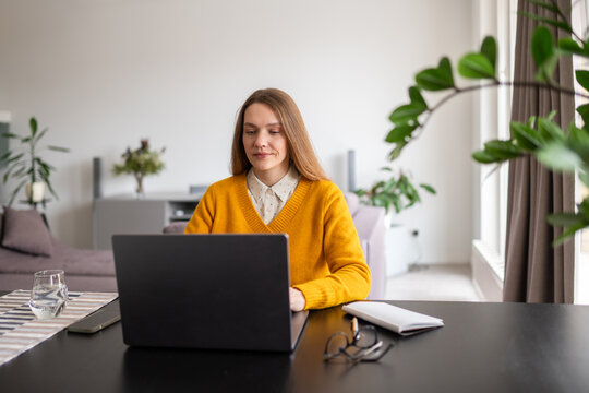 Woman using computer at home