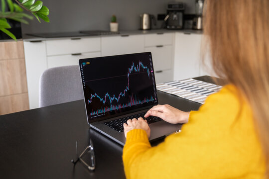 Woman analyzing stock chart at home