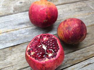 Sweet red pomegranate on a wooden table.