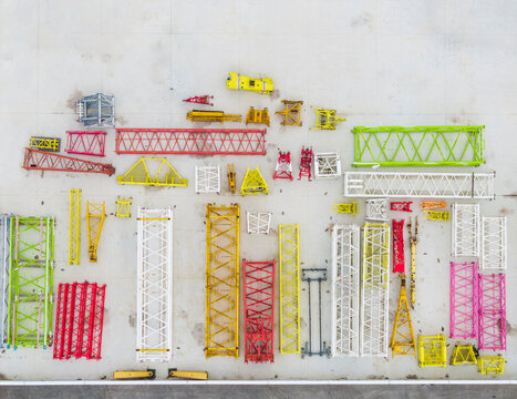 Colorful Tower Crane Sections Laid Out on Construction Yard