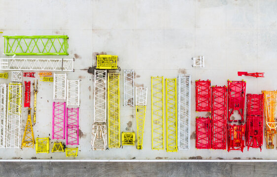 Colorful Tower Crane Sections Laid Out on Construction Yard