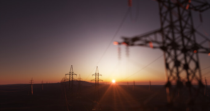 Huge power lines close up with a sunset landscape