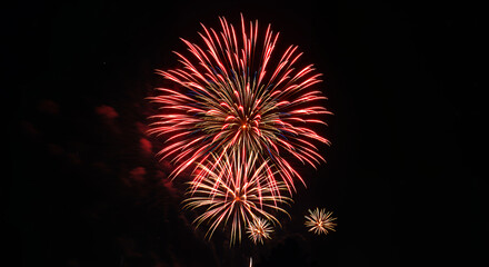 Fototapeta premium Spectacular Red and Gold Fireworks Display at Night Celebration Event