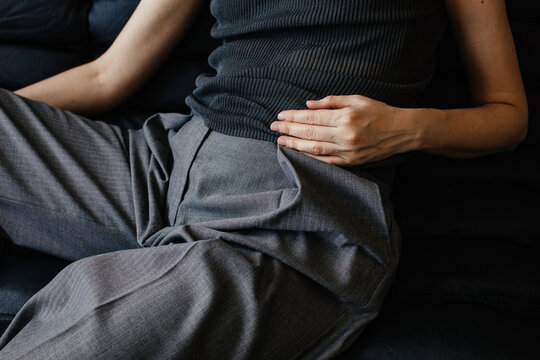 Anonymous fashionable woman with hand on belly