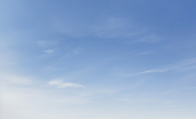 Blue sky with few wispy clouds on a clear bright day. luxury sky photos for landscape backgrounds and wallpapers.