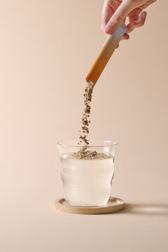 Dissolving Powder Into Water With a Glass and Bamboo Background