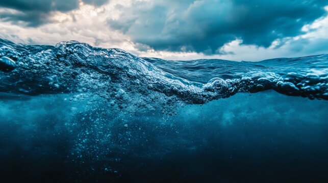 Waves crashing against the surface of the ocean, with a view from below and above.