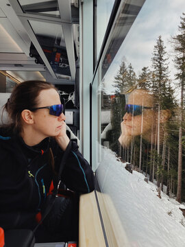 Woman and her reflection in train window