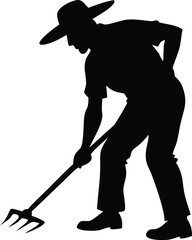 Silhouette of a farmer in a hat tilling the soil with a fork hoe shows agricultural labor