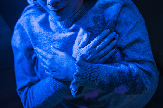 Woman meditating with her hands on her chest