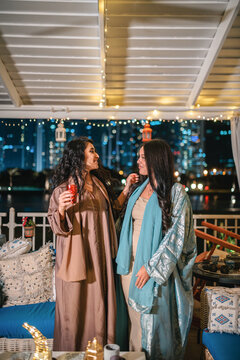 Two young beautiful Muslim woman wearing abayas