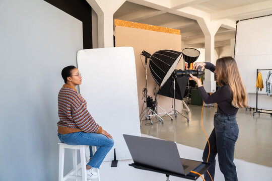 Model Posing To A Photographer At Spacious Studio 