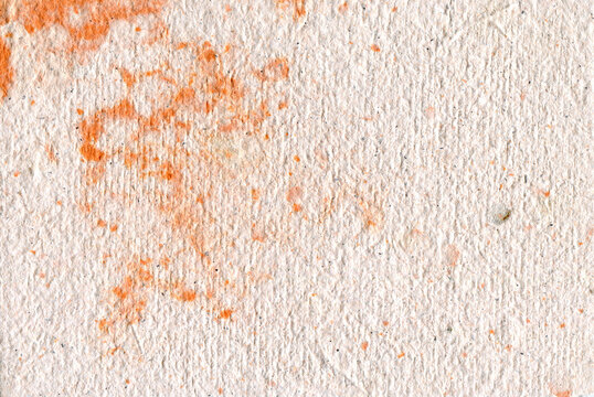 textured paper with orange paint