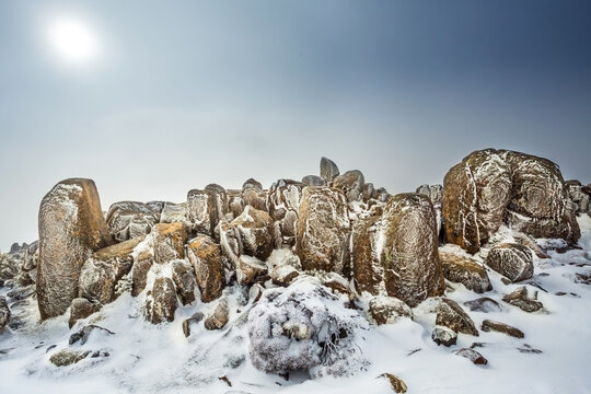 Ice rime build up and snaow on granite boulders