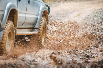 Off-road vehicles driving on muddy tracks. Mud and water splash in off-road racing. Offroad car expedition