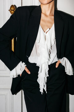 Anonymous female showcases fashion black suit outfit