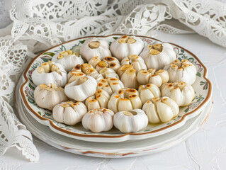 Roasted garlic heads on a decorative plate