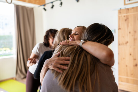 Women are hugging during group therapy session
