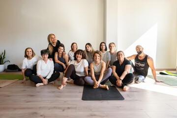 Group of people smiling during yoga class therapy and relaxation