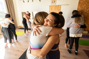 Women embracing during group therapy session promoting mental health