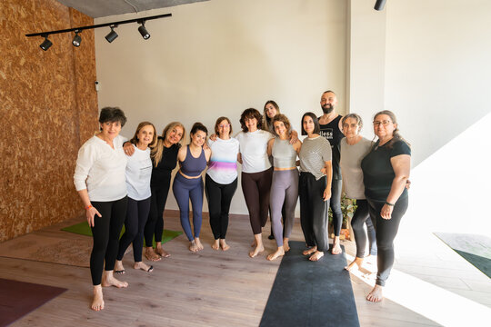Group of yogis embracing each other after yoga class
