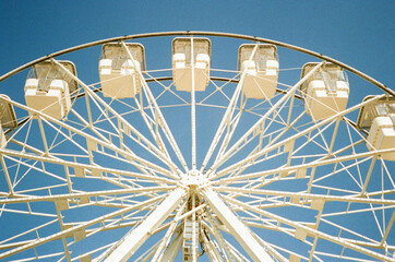 Film photo of the Ferris wheel on a sunny summer day