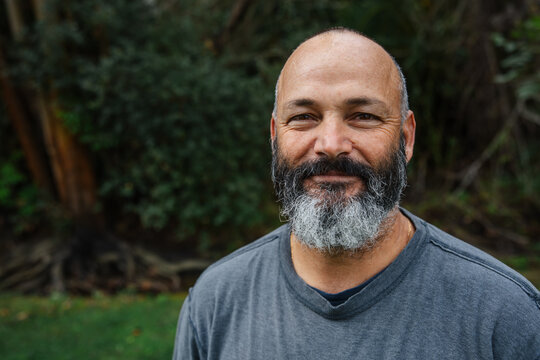 Smiling Bearded Man Outdoors in a Relaxed Natural Setting