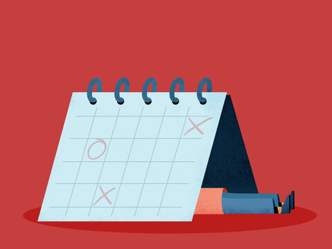 Crop person lying under desk calendar