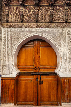 Ornate Wooden Door with Islamic Architecture  
