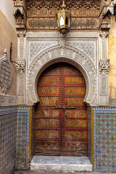 Ornate Wooden Door with Islamic Architecture  
