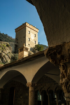 Historic stone tower framed by ancient arches