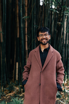 Young man with glasses is looking at the camera very cheerful.