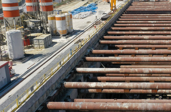 Industrial Construction Site Featuring Pipes and Machinery in Progress
