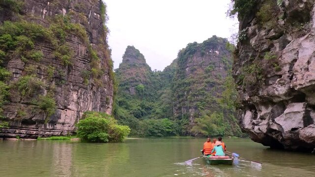 Trang An River Ninh Minh and Bai Dinh Mountain ranges in Vietnam only 3 hours drive from Hanoi. Beautiful winding river and large rising mountains. boats going through the caves in the river