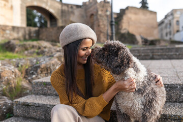 Latina woman with her dog outdoors