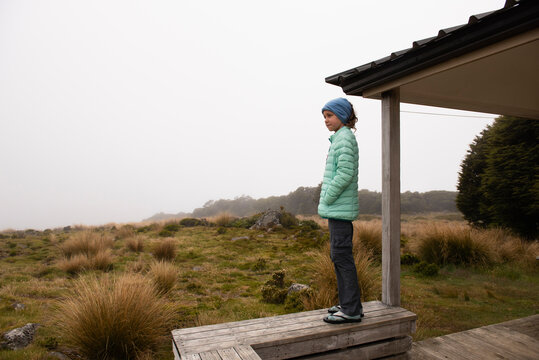 Young girl waiting out the weather, mountains of New Zealand.