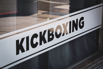 Kickboxing sign on urban window  
