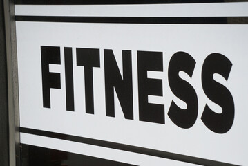 Fitness sign on urban window  