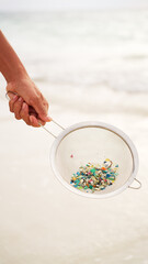 microplastics in water environment, plastic particles and pieces pollution in ocean and on beach, polluted nature, single-use trash