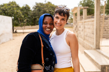 Happy multi ethnic women embracing and smiling in Senegal