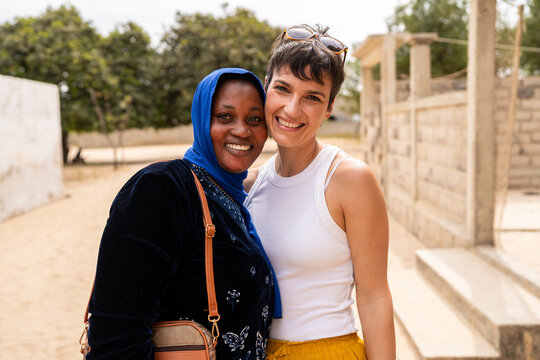 Happy multi ethnic women embracing and smiling in Senegal