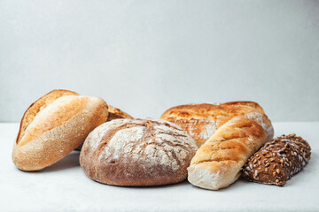 Freshly baked breads displayed on a clean white surface in a cozy setting