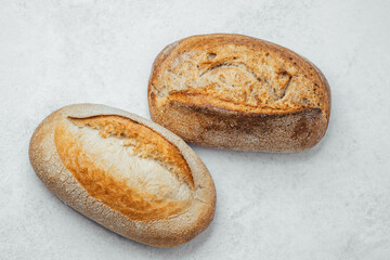 Freshly baked bread loaves on a light surface ready for serving