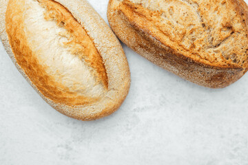 Freshly baked rustic bread loaves on a light background in a cozy kitchen