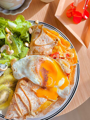 Banana and eggs tortilla wrap with mixed fruits for breakfast. Delicious food. Bruch menu. Healthy recipes. Easy home cooking. Diet food dish. High Protein. eggs recipe. Easy breakfast. Tropical fruit
