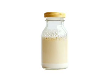 Creamy beverage in a glass bottle sealed with a yellow cap isolated on black