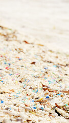 Microplastic on beach, plastic particles in sand, ocean pollution, single-use waste, rubbish in the sea, polluted nature and environmental crisis