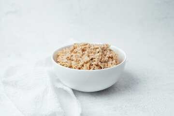 Delicious bowl of cooked rice with a simple presentation on a light background