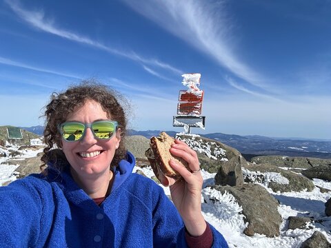 UGC officer with sandwich on th peak on a mountain 